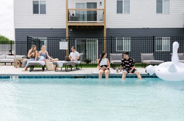 Sparkling blue pool surrounded by lounge chairs.