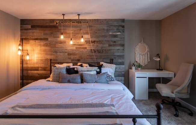 This is a photo of the bedroom with barb wood wall in the upgraded 650 square foot, 1 bedroom, 1 bath model apartment at Deer Hill Apartments in Cincinnati, Ohio.