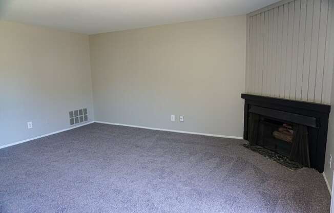 Fireplace and spacious living room at Woodcrest Apartments in Westland, Michigan