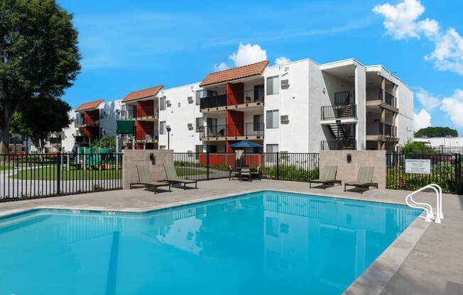 a swimming pool in front of an apartment building