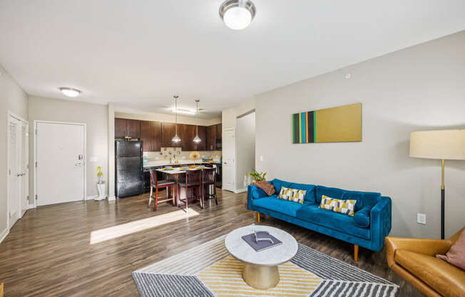 A living room with a blue couch and a coffee table.