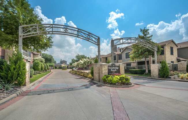 A gated entrance to a residential area with a sign that reads