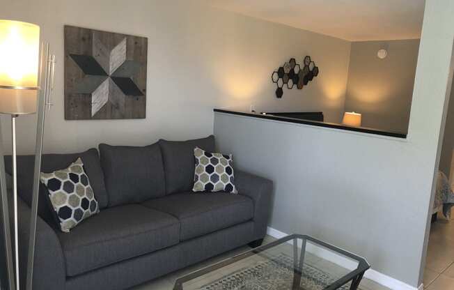 a living room with a couch and a coffee table at Colonial Apartments, Orlando, FL 32808