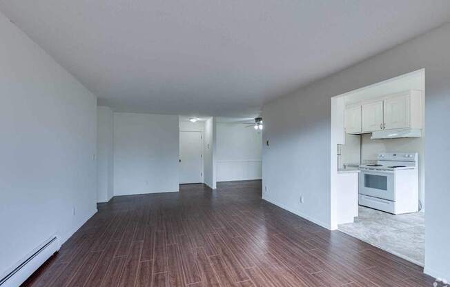 A room with wooden floors and white walls.