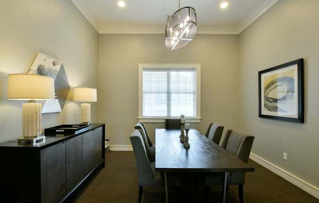 A dining room with a table and chairs.