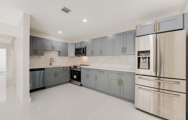 Fully renovated stylish 3 bed 2 bath home featuring a luxury kitchen, modern appliances on a fenced lot with parking!
