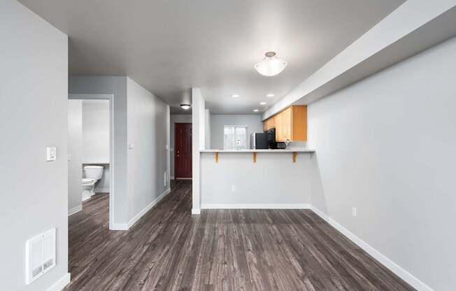 A room with wooden floors and white walls.
