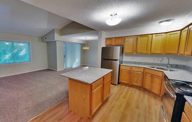 a kitchen with wooden cabinets and stainless steel appliances