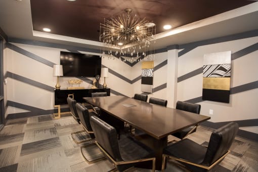 a dining room with a table and chairs and a chandelier