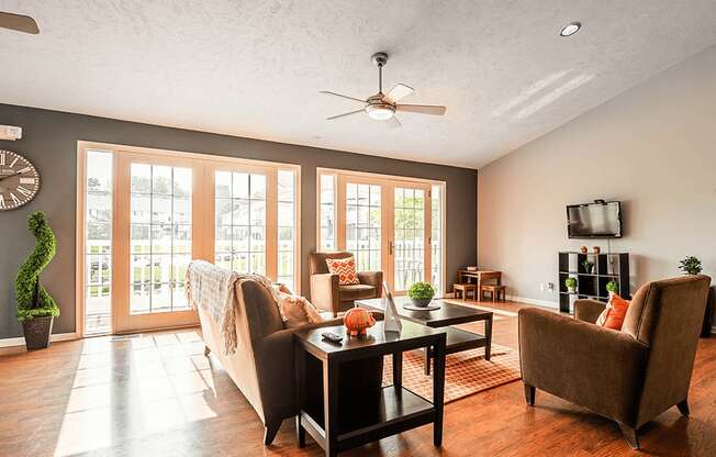 a living room with hardwood floors and a ceiling fan