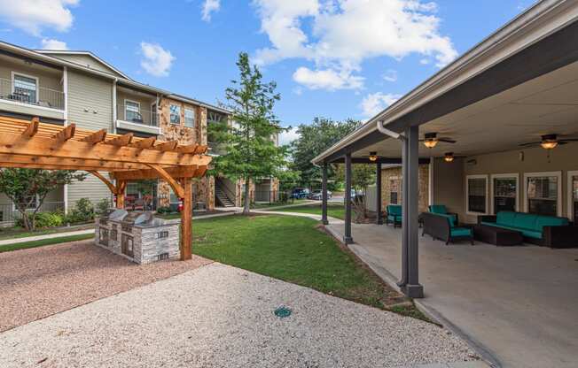 a backyard with a covered patio and a fire pit