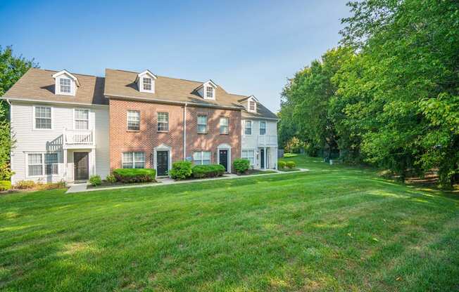 a large lawn in front of a brick house at Traditions at Slate Ridge, Ohio