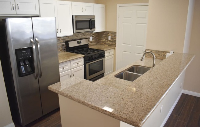 view of kitchen with white cabinets an stainless appliances