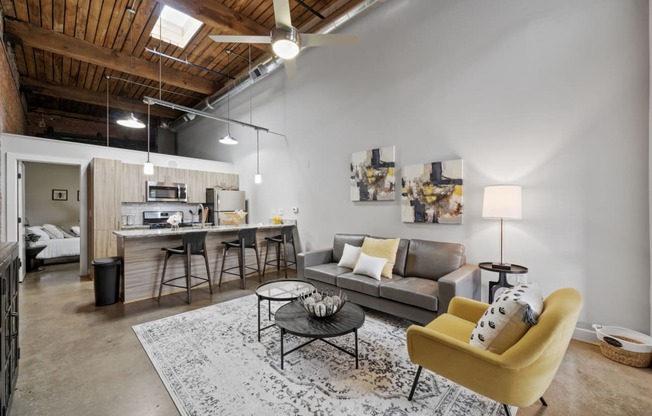 a living room with white walls and a wooden ceiling