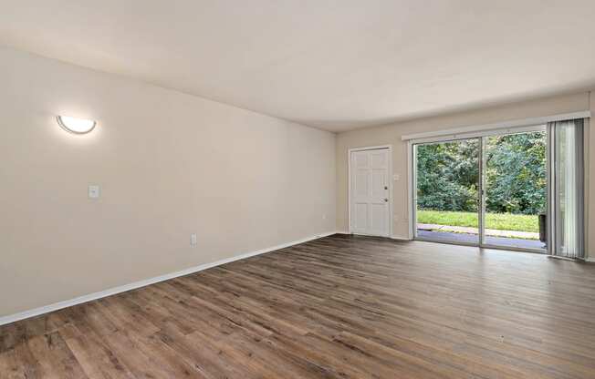 a living room with hardwood floors and a sliding glass door