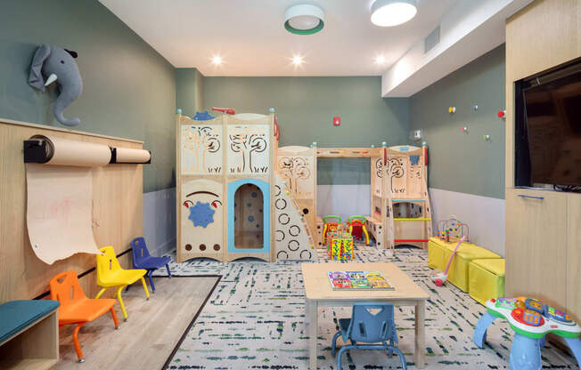 a play room with a castle and toys on the floor