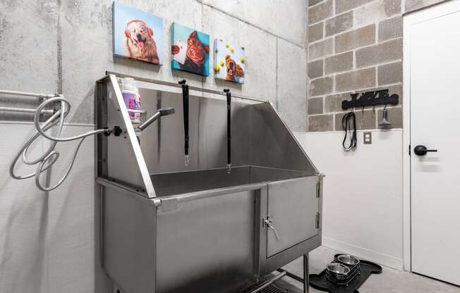 a large stainless steel sink in a room with a white door