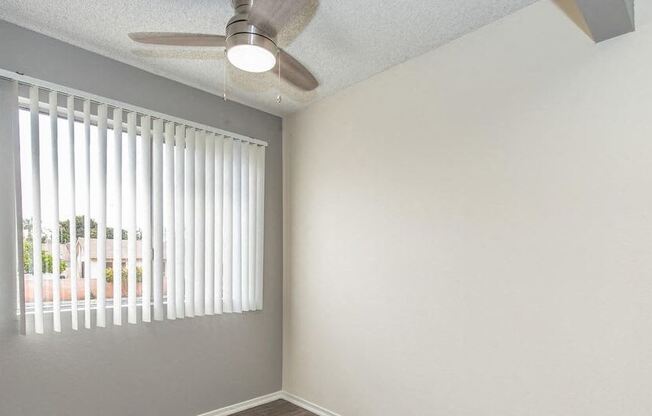 an empty room with a window and a ceiling fan at Villa La Paz Apartments, Bellflower, 90706