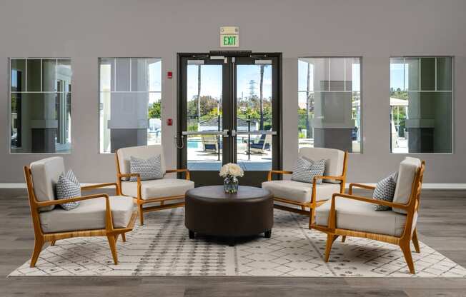 a lobby with chairs and a table in front of a door