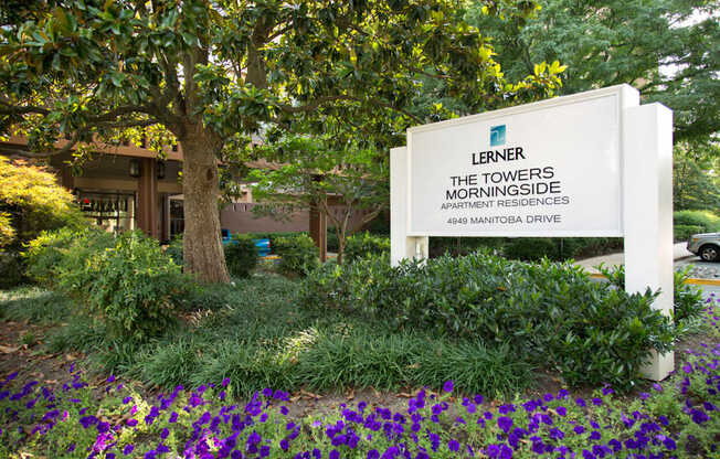 A white sign with the name Lerner and The Towers Morningside Apartment Residences on it.