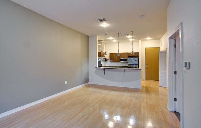 Shiny hardwood floors in organic finishing apartment Living Room at The Mosaic on Broadway, San Antonio, TX, 78215