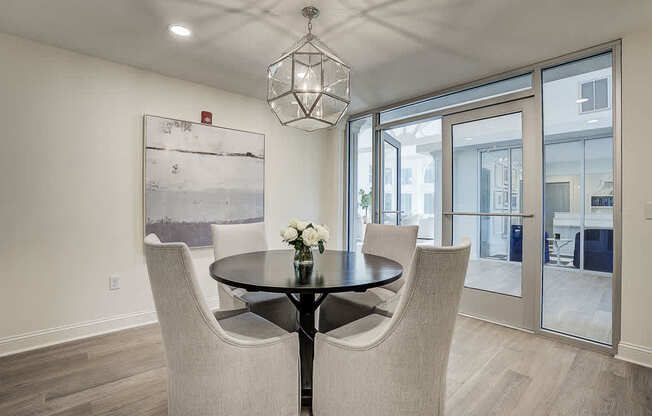 A dining room with a table and chairs.