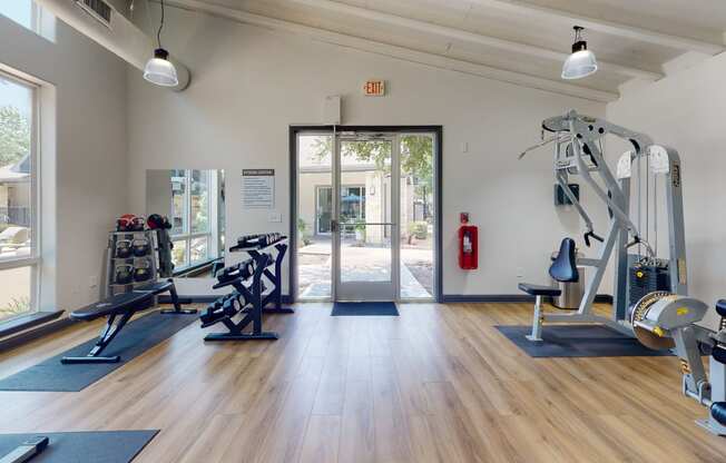 a gym with exercise equipment and a fire hydrant in the background