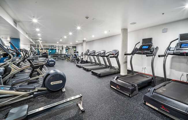 A gym with treadmills, elliptical machines, and other exercise equipment at Esprit Marina del Rey, 90292