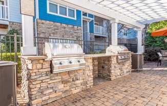 the preserve at ballantyne commons covered patio with two grills and a bar