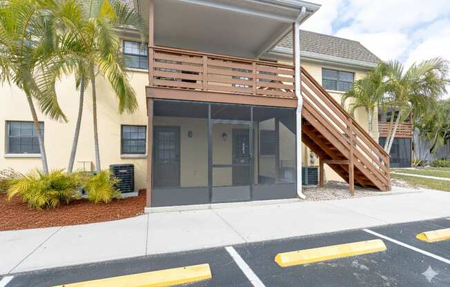 A building with a wooden staircase leading to the entrance.