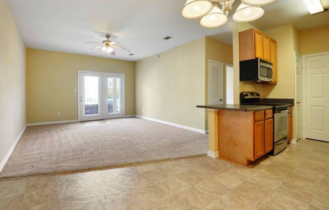 A kitchen area with a microwave, oven, and cabinets.