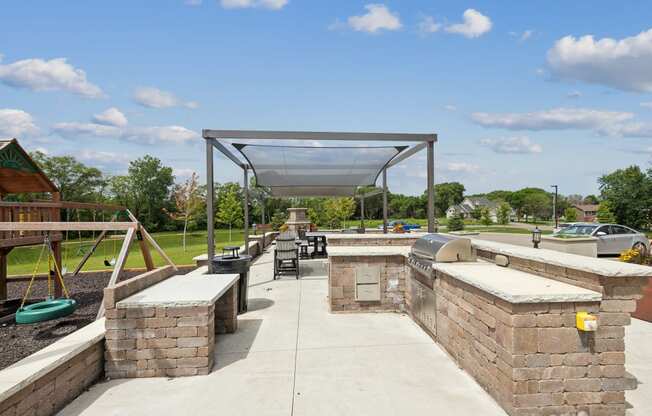 a picnic area with benches and awnings at a park