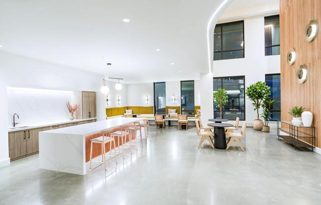 A bright gathering space with a sleek kitchen, lounge seating, and room to connect.