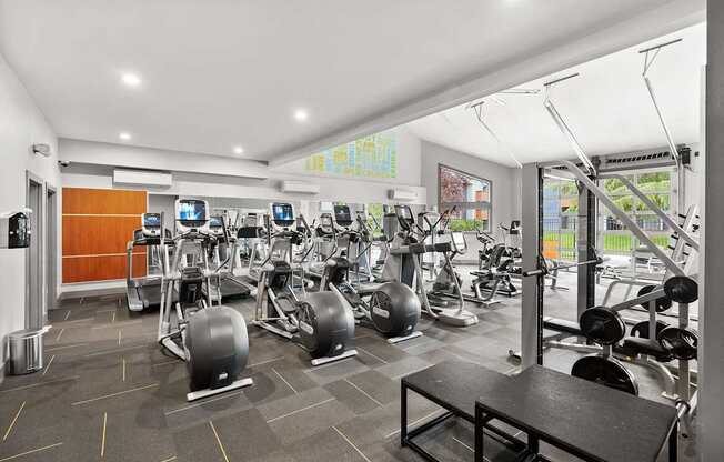 A gym with a variety of equipment including treadmills, stationary bikes, and weight machines. at Northpoint Apartments, Tacoma, Washington