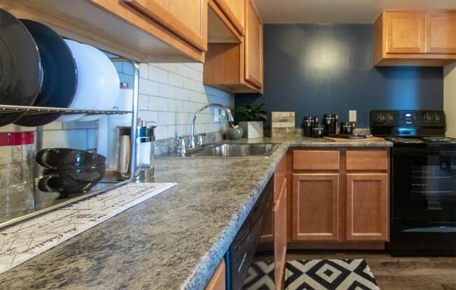 This is a picture of the kitchen in an upgraded 980 square foot, 2 bedroom, 1 bath model apartment at Fairfield Pointe Apartments in Fairfield, Ohio.