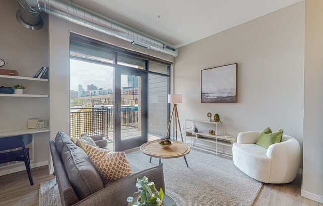a living room with a sliding glass door and a balcony