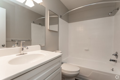 a bathroom with a sink toilet and a tub