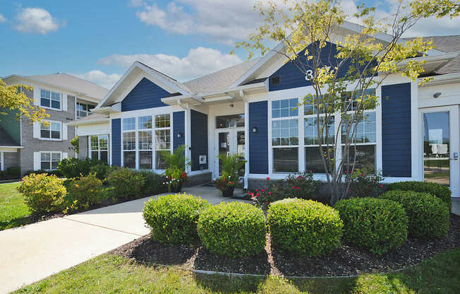 A row of houses with blue trim and white siding.