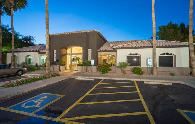 A parking lot with a disabled parking sign painted on the pavement at Sterling Point Apartment Homes, Phoenix, AZ