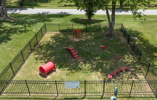 an aerial view of a dog park with a dog kennel and playground equipment at Stonewater Apartments, Louisville