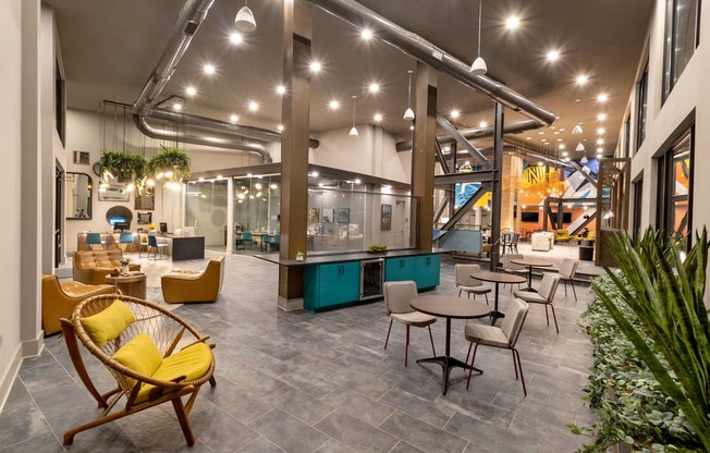 the lobby of a building with tables and chairs