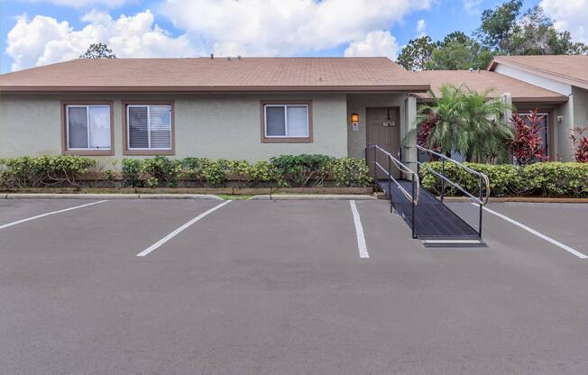 an empty parking lot in front of a house