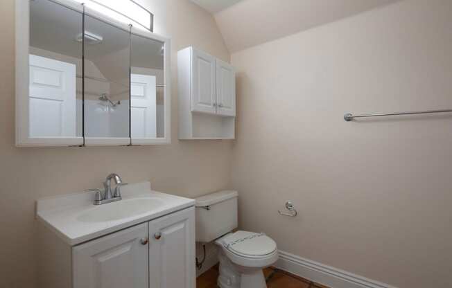 Bathroom with white fixtures and Saltillo flooring at the Atrium Apartments in San Diego, California.