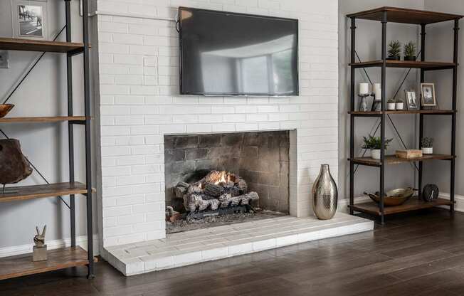 A modern living room with a fireplace and a flat screen TV mounted above it