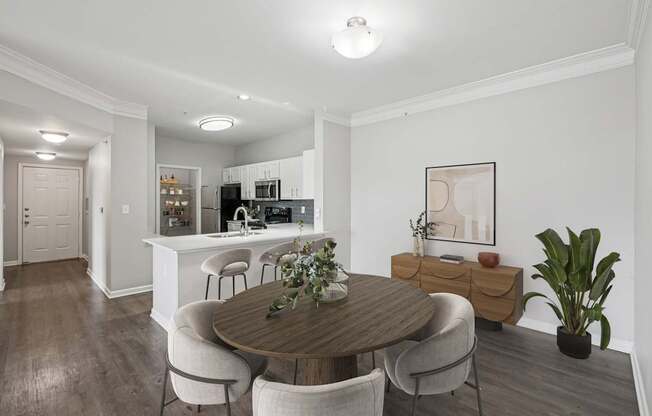 A dining room with a wooden table and chairs.