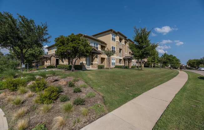 Apartment complex with a walkway at Woodbridge Villas Apartments, Sachse, TX, 75048