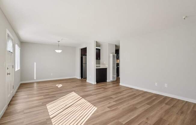 A room with a striped rug on the wooden floor.