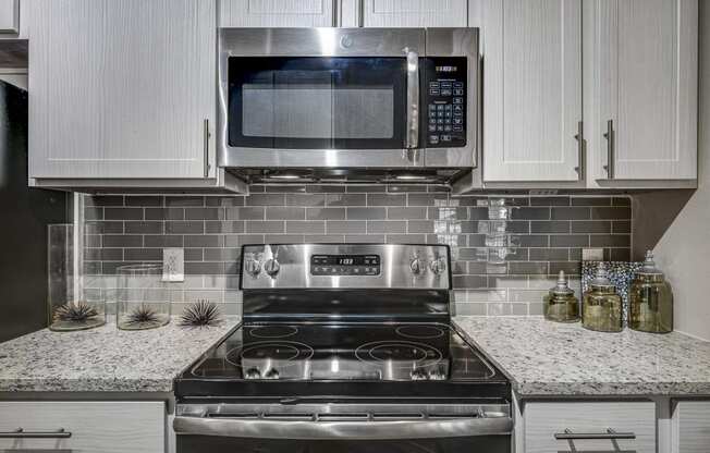 Electric Range In Kitchen at Riachi at One21, Plano, Texas