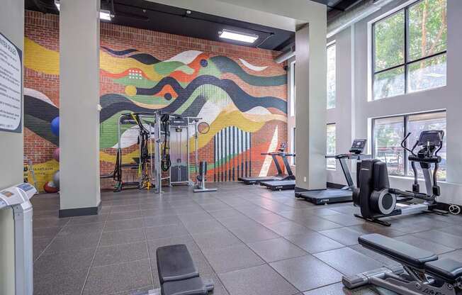 A gym with a colorful mural on the wall.