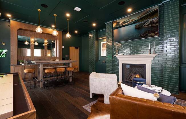 a living room with a fireplace and a bar at The Bohen Apartments , Minnesota, 55408